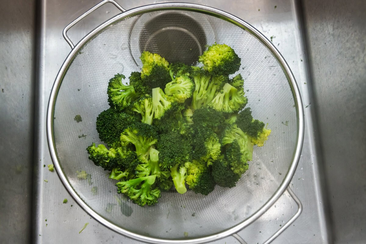 broccoli florets in a strainer