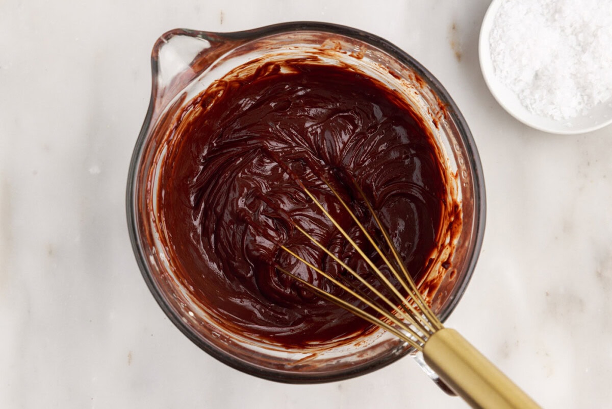 whisking chocolate ganache in a bowl