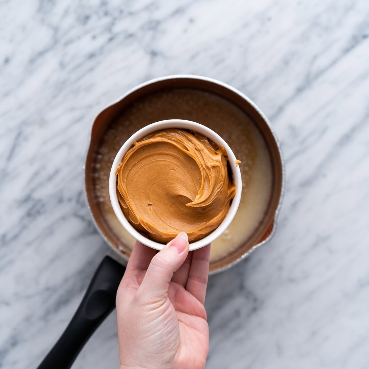 adding creamy peanut butter to butter mixture