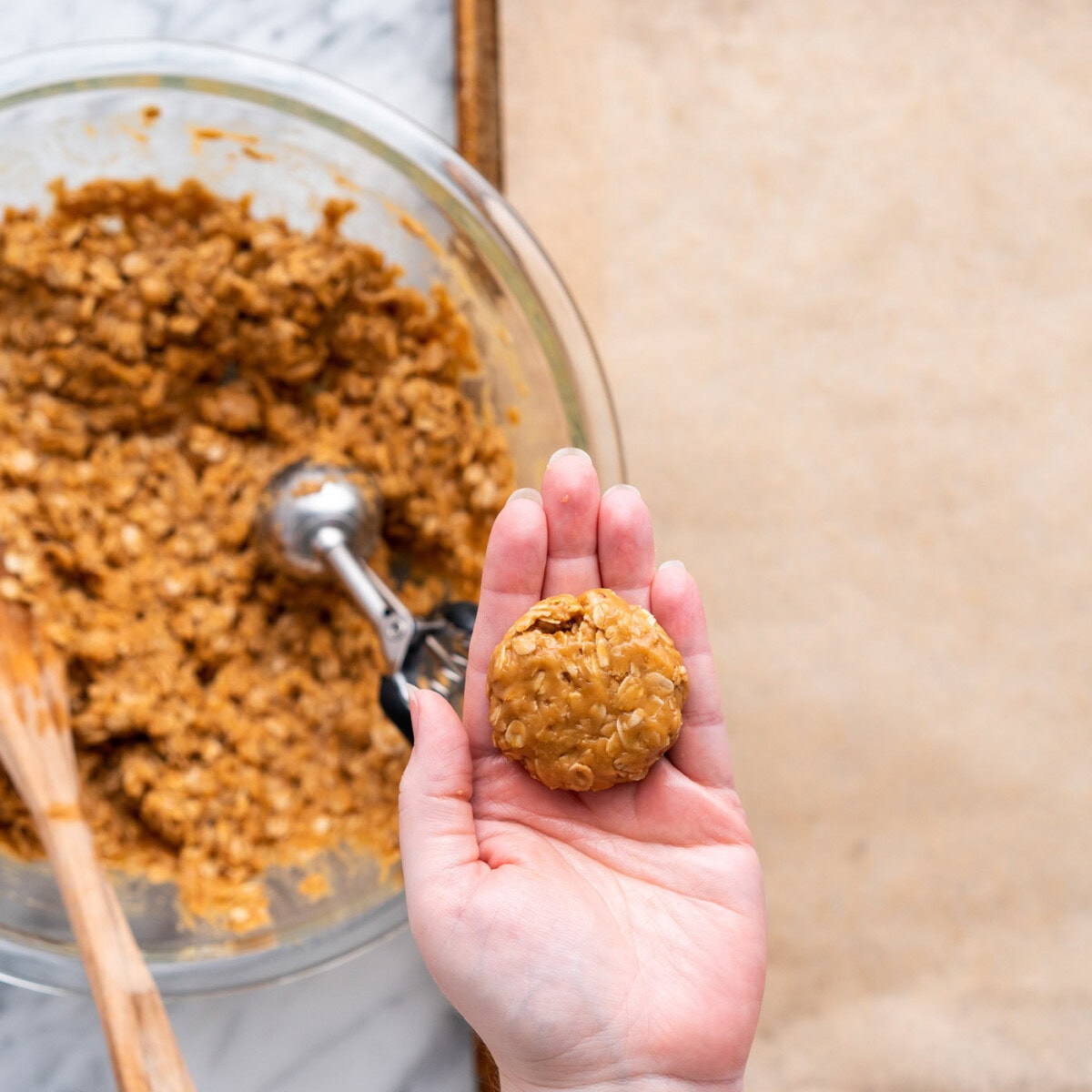 flattened peanut butter cookie dough ball in palm of hand