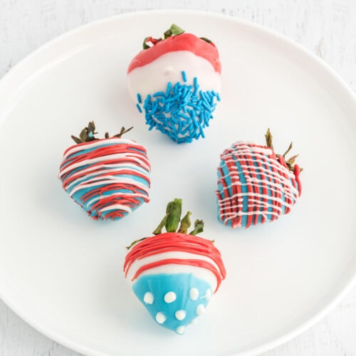 Four Patriotic Chocolate Covered Strawberries on a plate