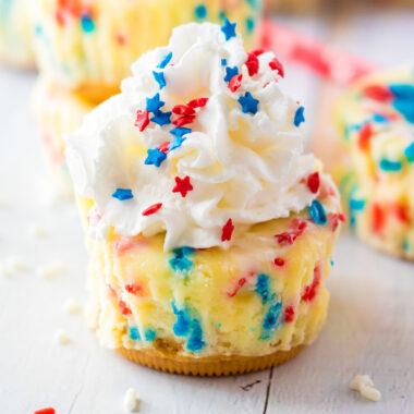 Close up photo of a Patriotic Mini Cheesecake topped with whipped cream
