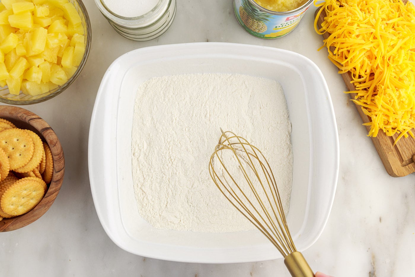 whisking flour and sugar in a baking dish