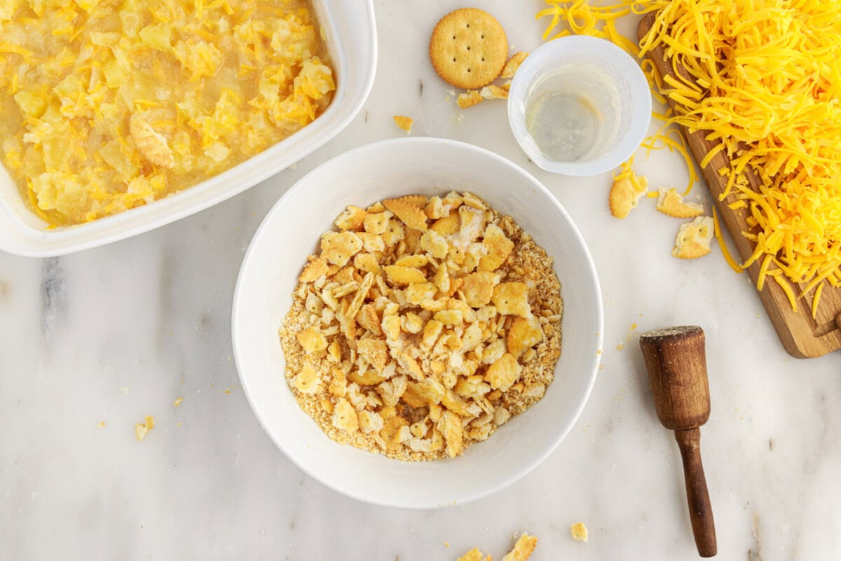 crushed ritz crackers with melted butter in a bowl