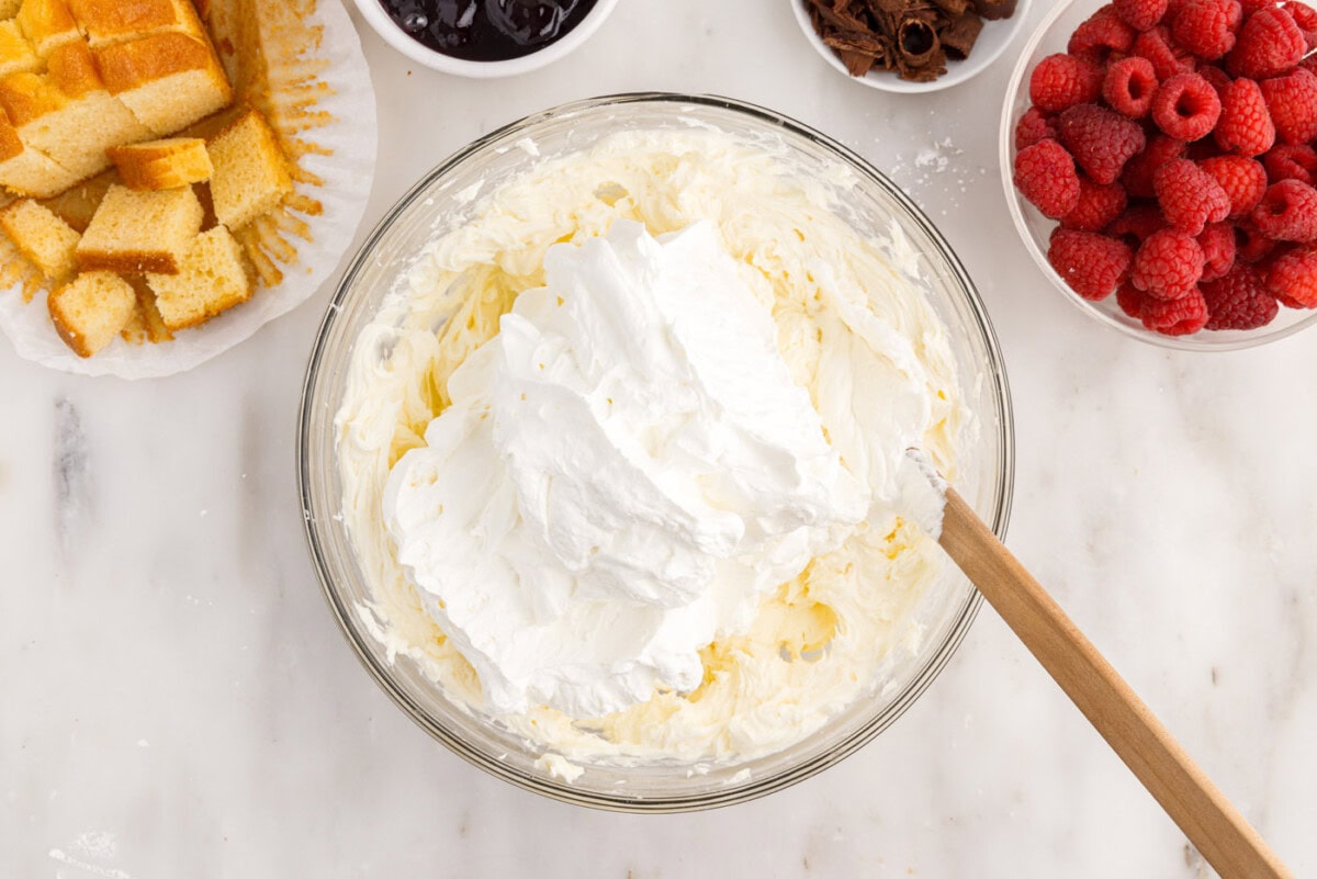 folding whipped cream into cream cheese mixture