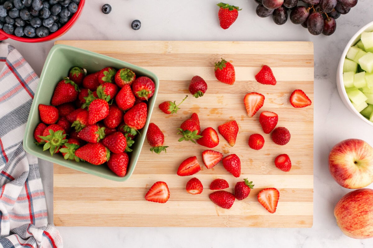 sliced strawberries on a cutting board