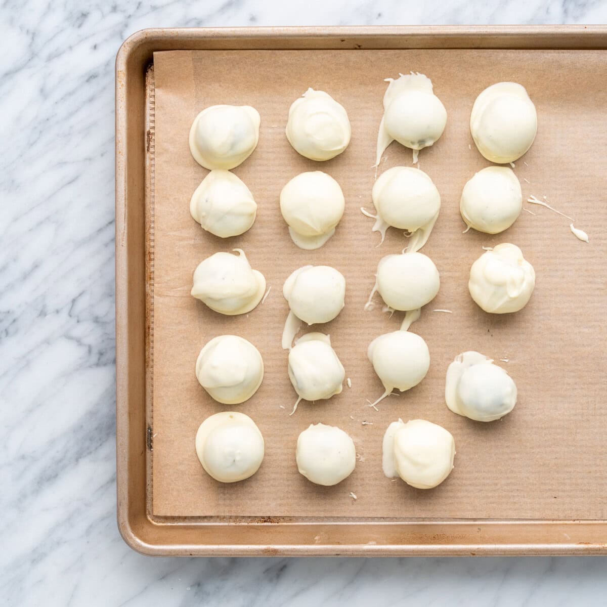 white chocolate oreo truffles on a baking sheet