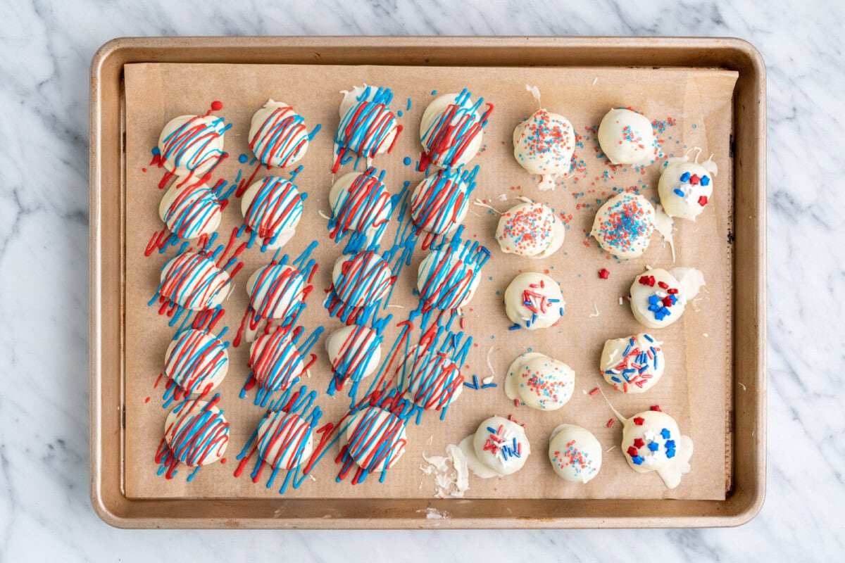 patriotic decorated oreo truffles on a baking sheet