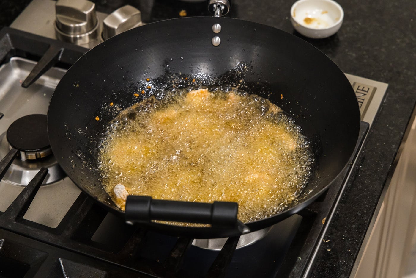shrimp in hot oil in a wok
