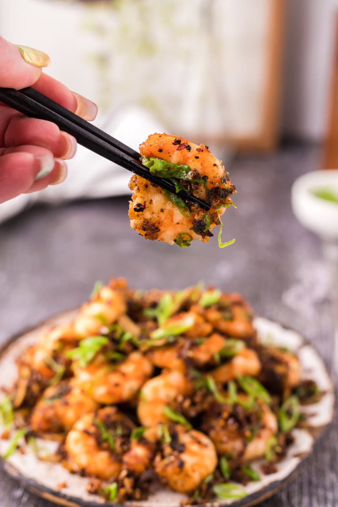 Chopsticks holding a Salt and Pepper Shrimp