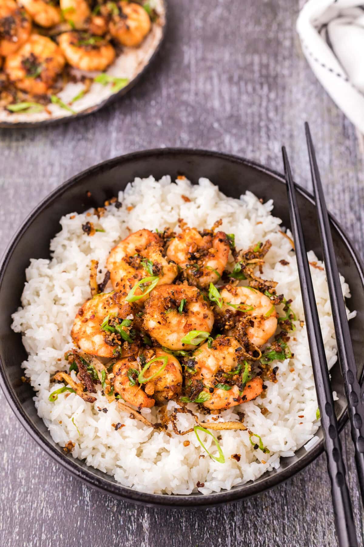 Salt and Pepper Shrimp in a bowl served over rice