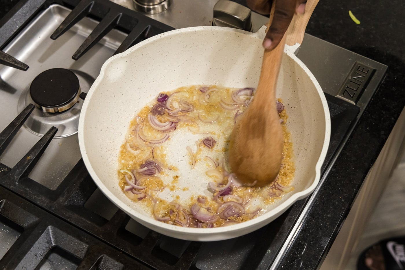 mixing shallots and garlics in a pan
