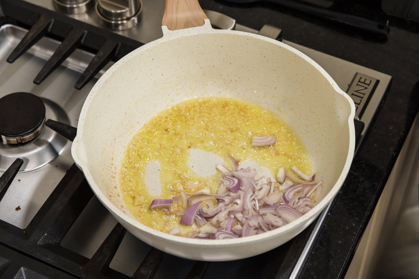 shallots with olive oil, garlic, and butter in a skillet