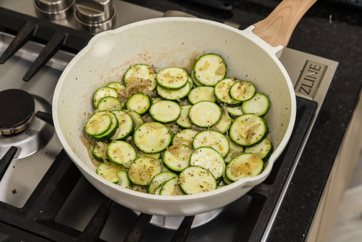 sliced zucchini with seasonings in a skillet