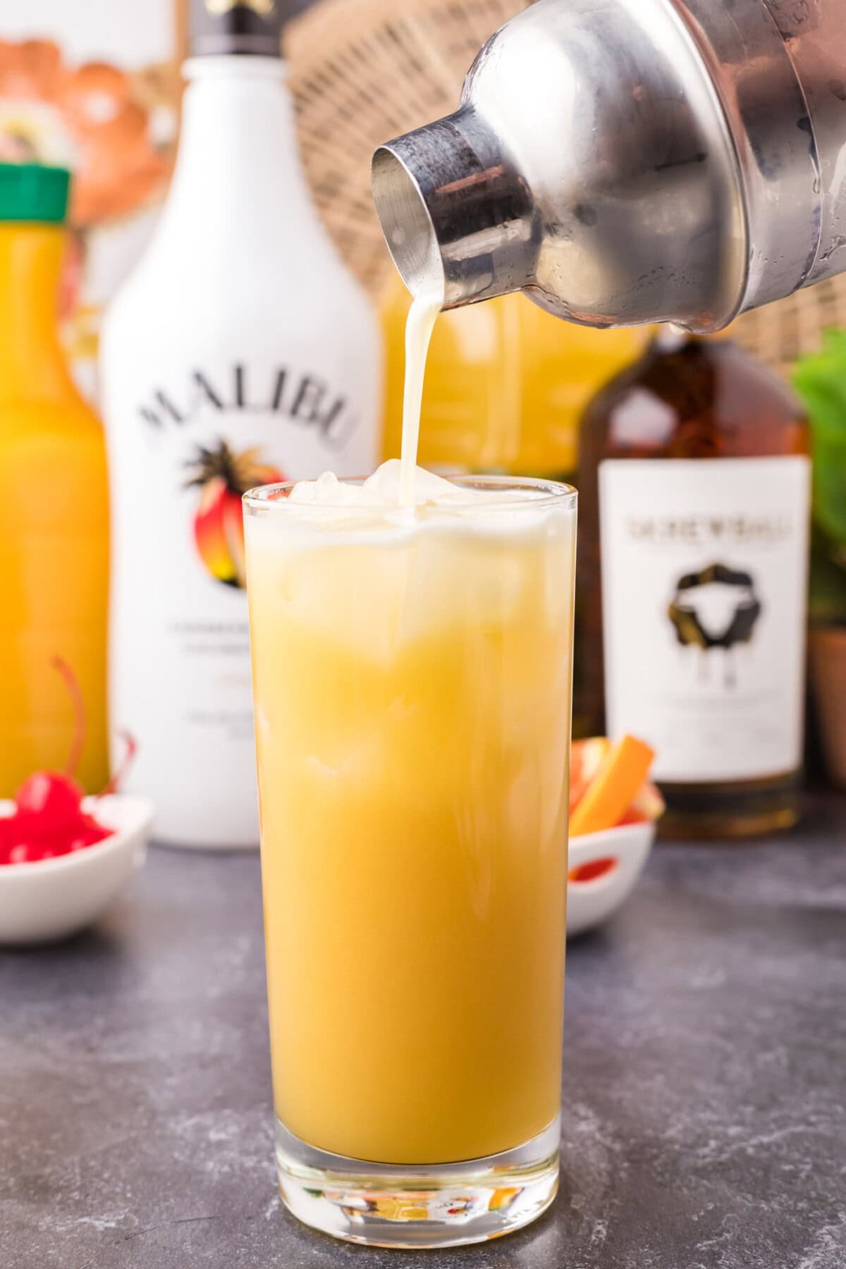 pouring screw loose cocktail into a glass