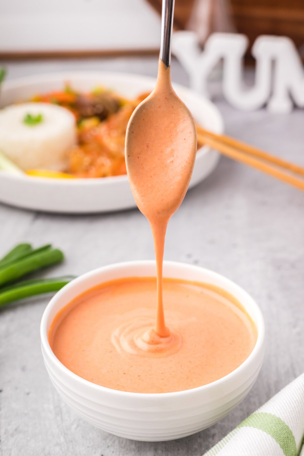 Yum Yum Sauce being drizzled off of a spoon