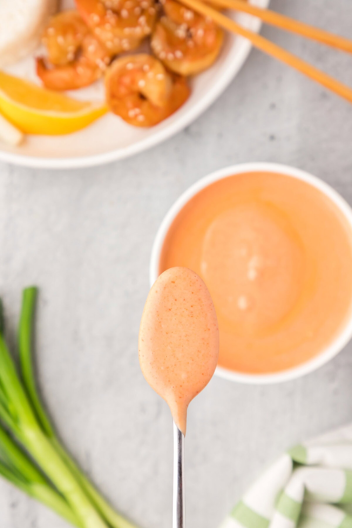 Spoonful of Yum Yum Sauce held over the bowl of Yum Yum Sauce