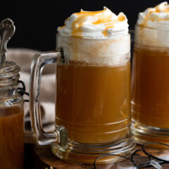 Close up photo of Butterbeer topped with whipped cream and butterscotch syrup