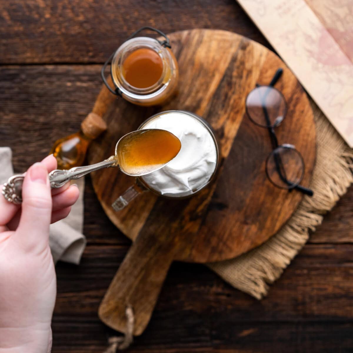 drizzling butterscotch syrup over butterbeer and whipped cream