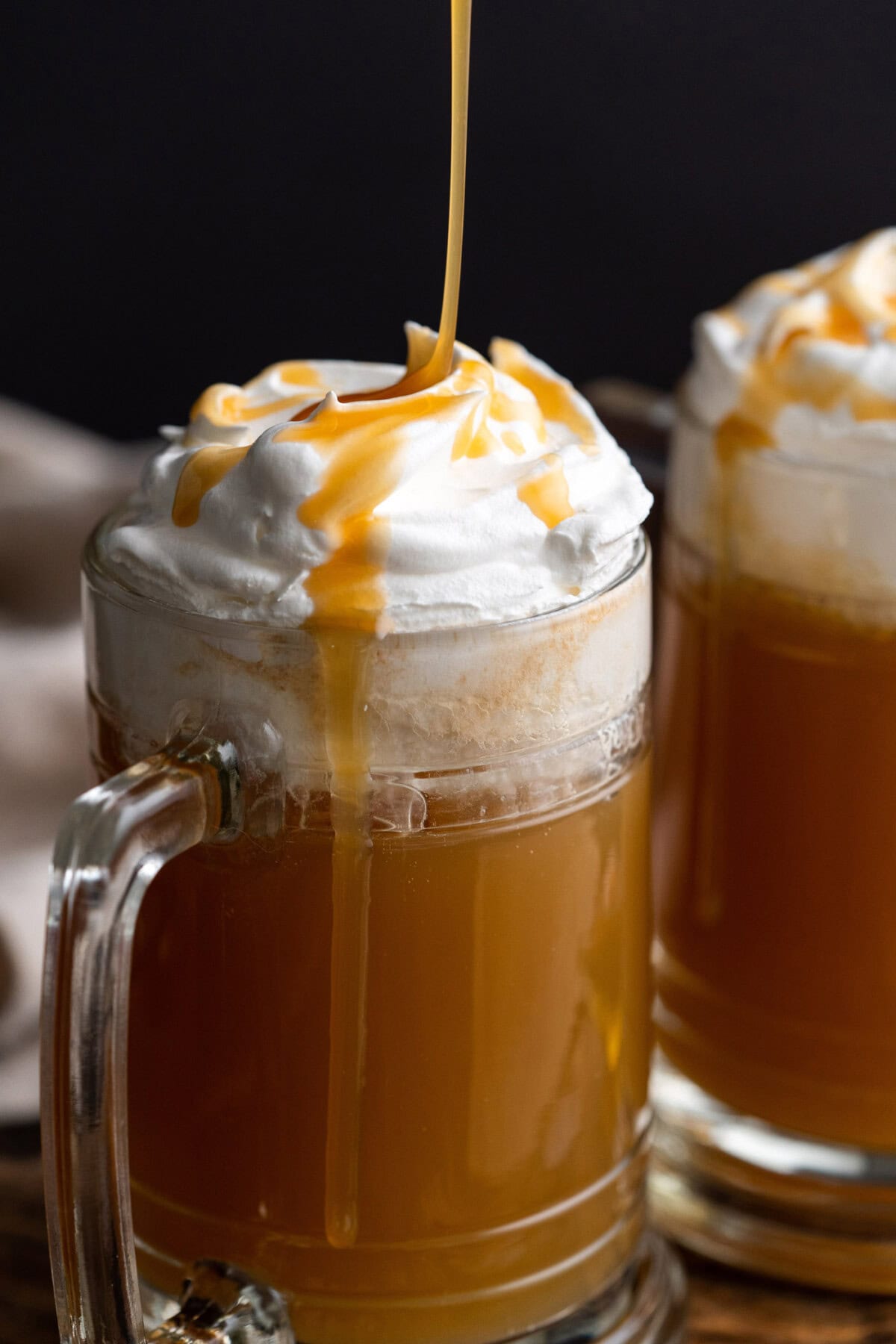 Butterscotch syrup being drizzled over Butterbeer