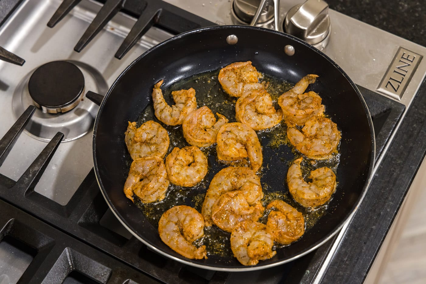 cajun shrimp in a skillet with oil
