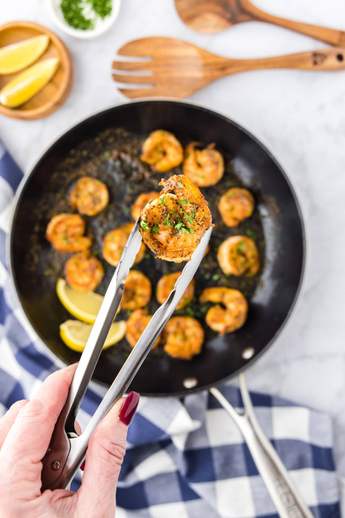 Tongs holding a Cajun Shrimp