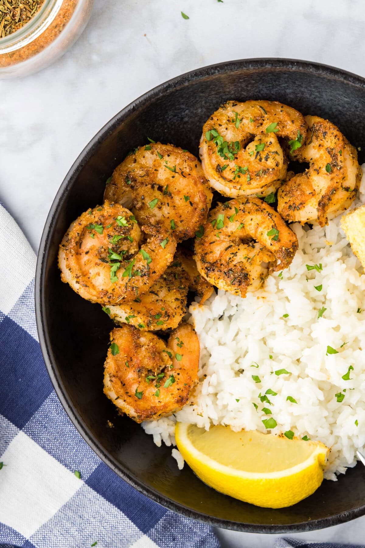 Close up photo of Cajun Shrimp in a bowl with rice