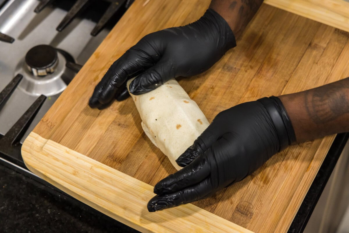 hands holding chicken bacon ranch wrap