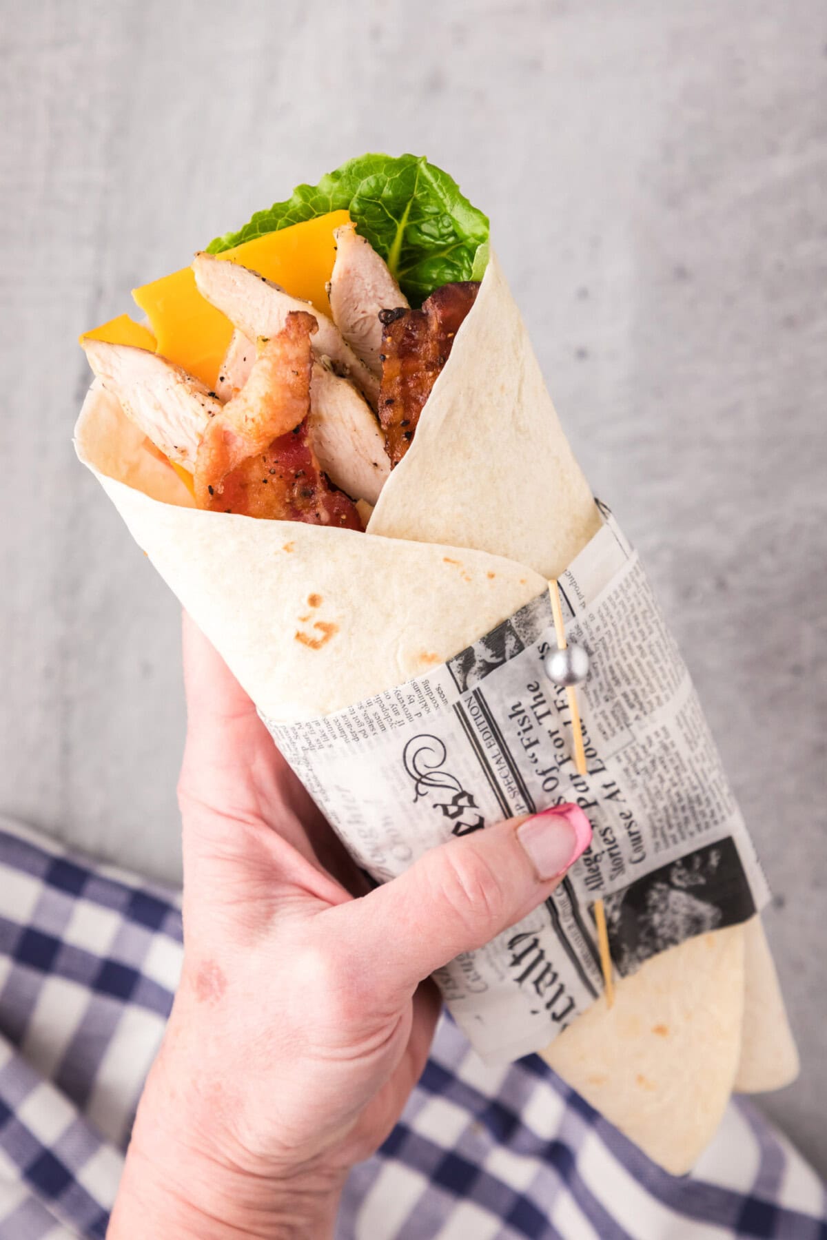 Hand holding a Chicken Bacon Ranch Wrap
