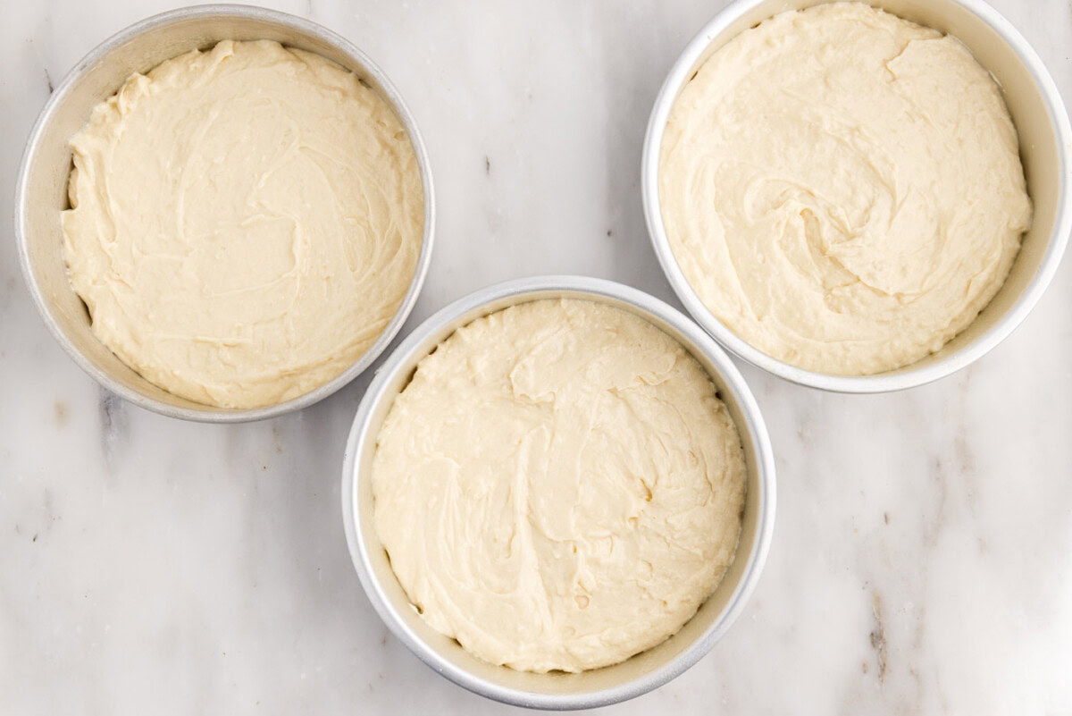 coconut cake batter in pans