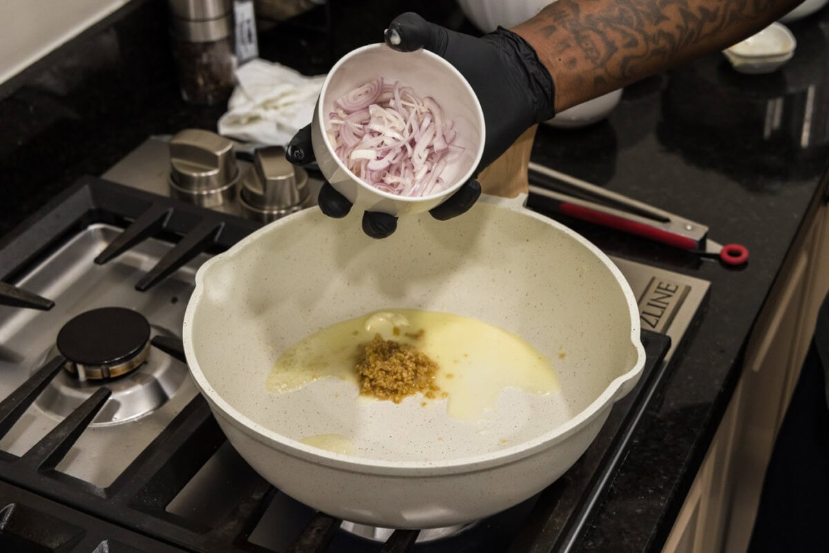 adding shallots to skillet with butter and garlic