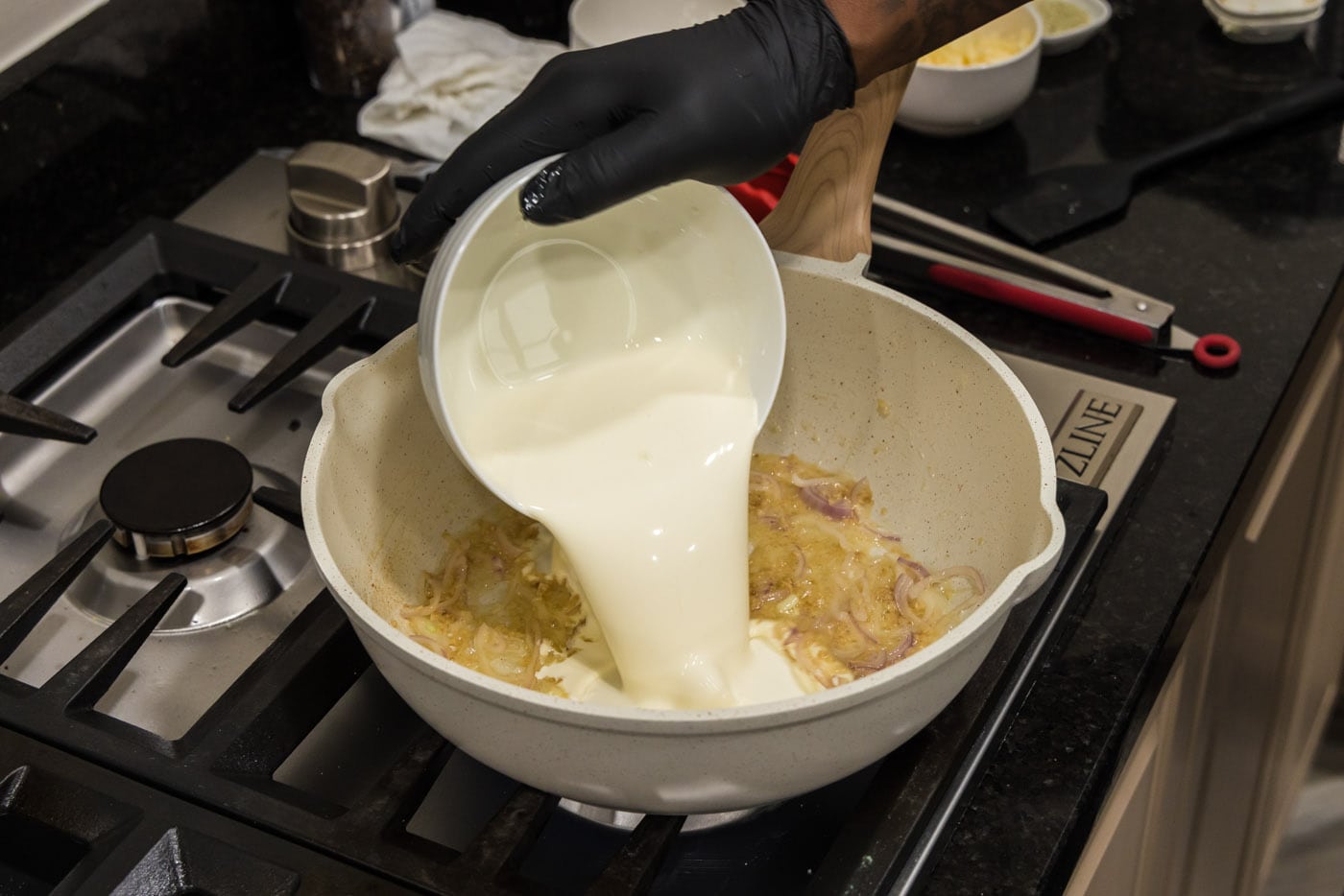 pouring heavy cream into skillet