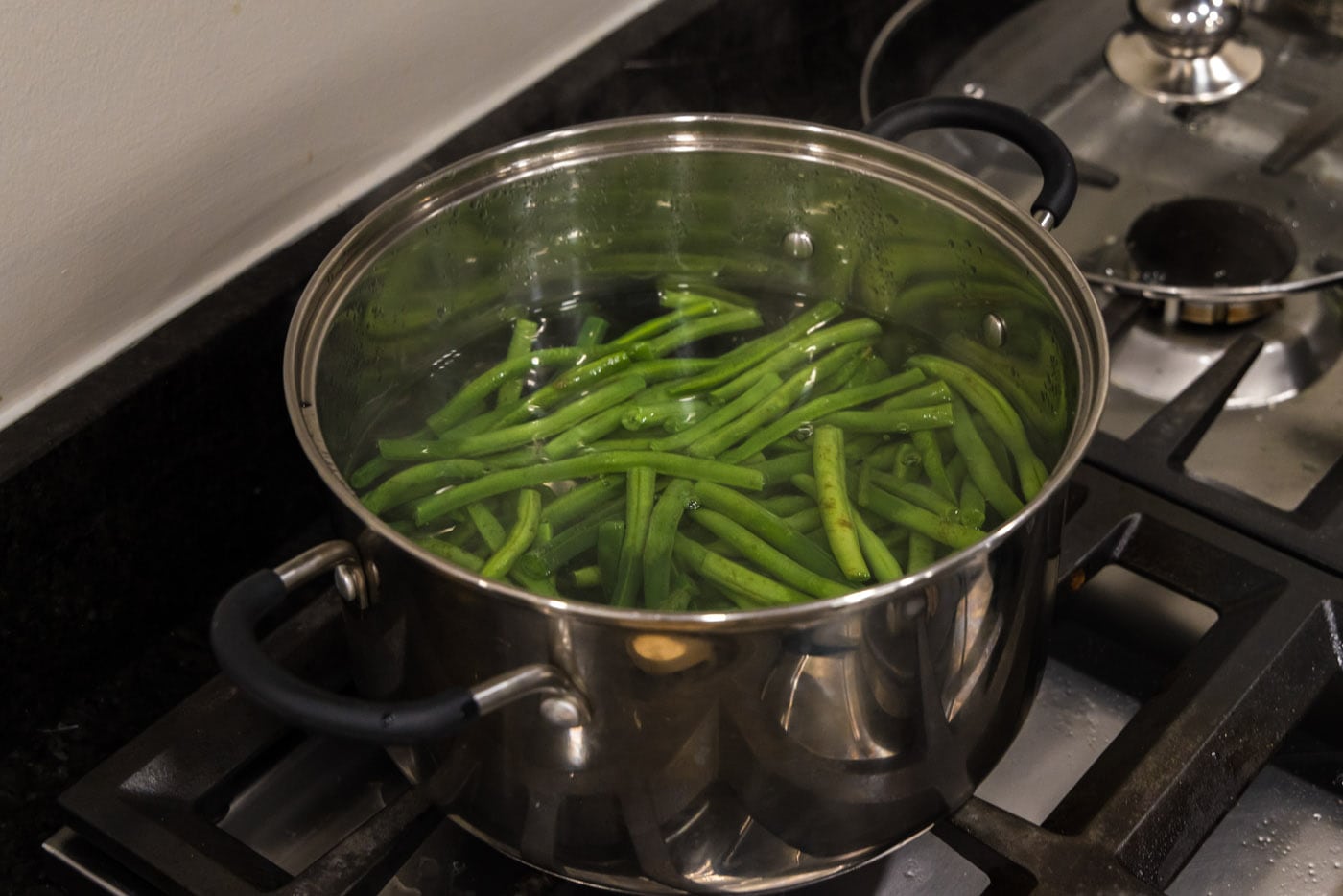 boiling green beans in a pot