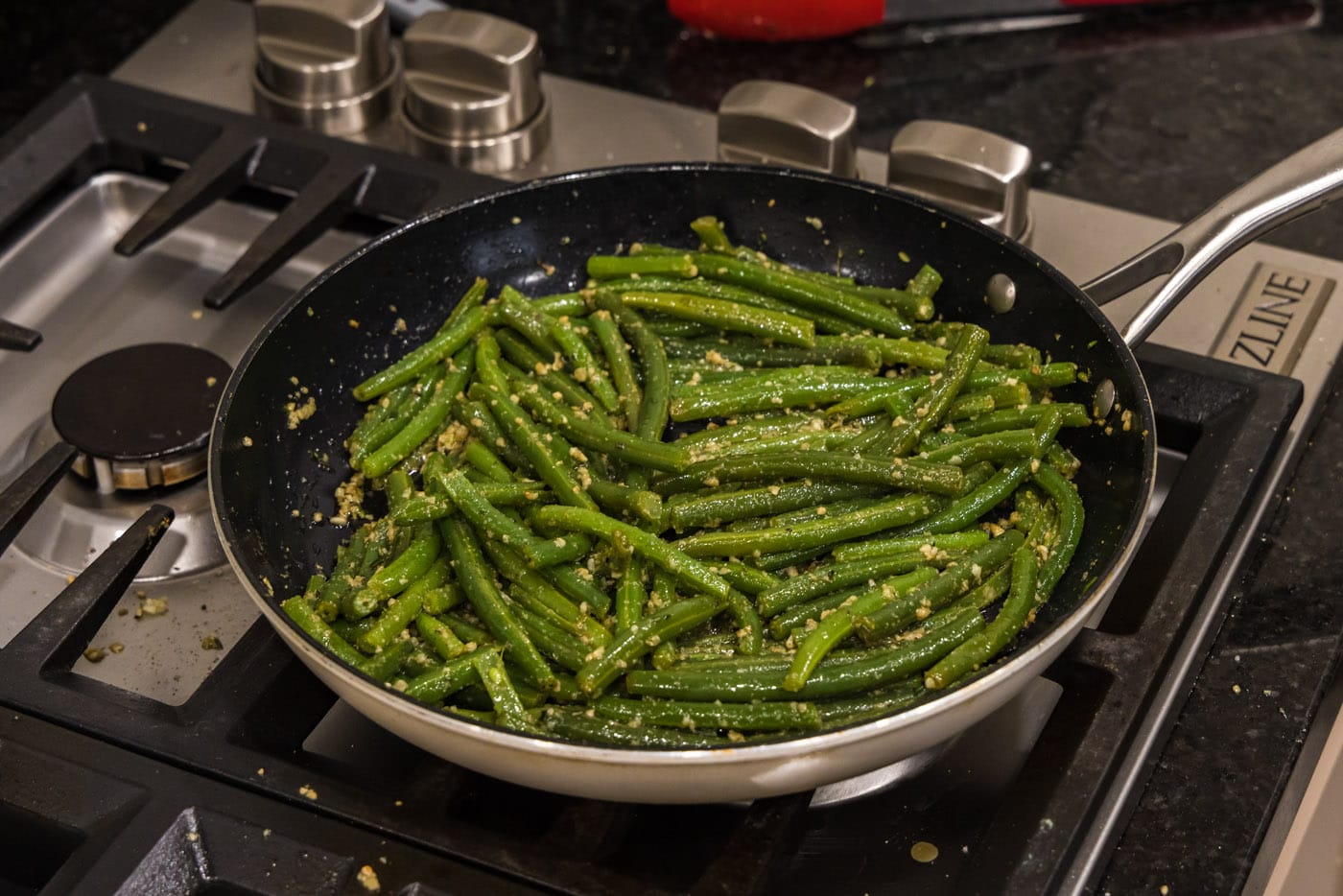 sauteed garlic green beans in a skillet