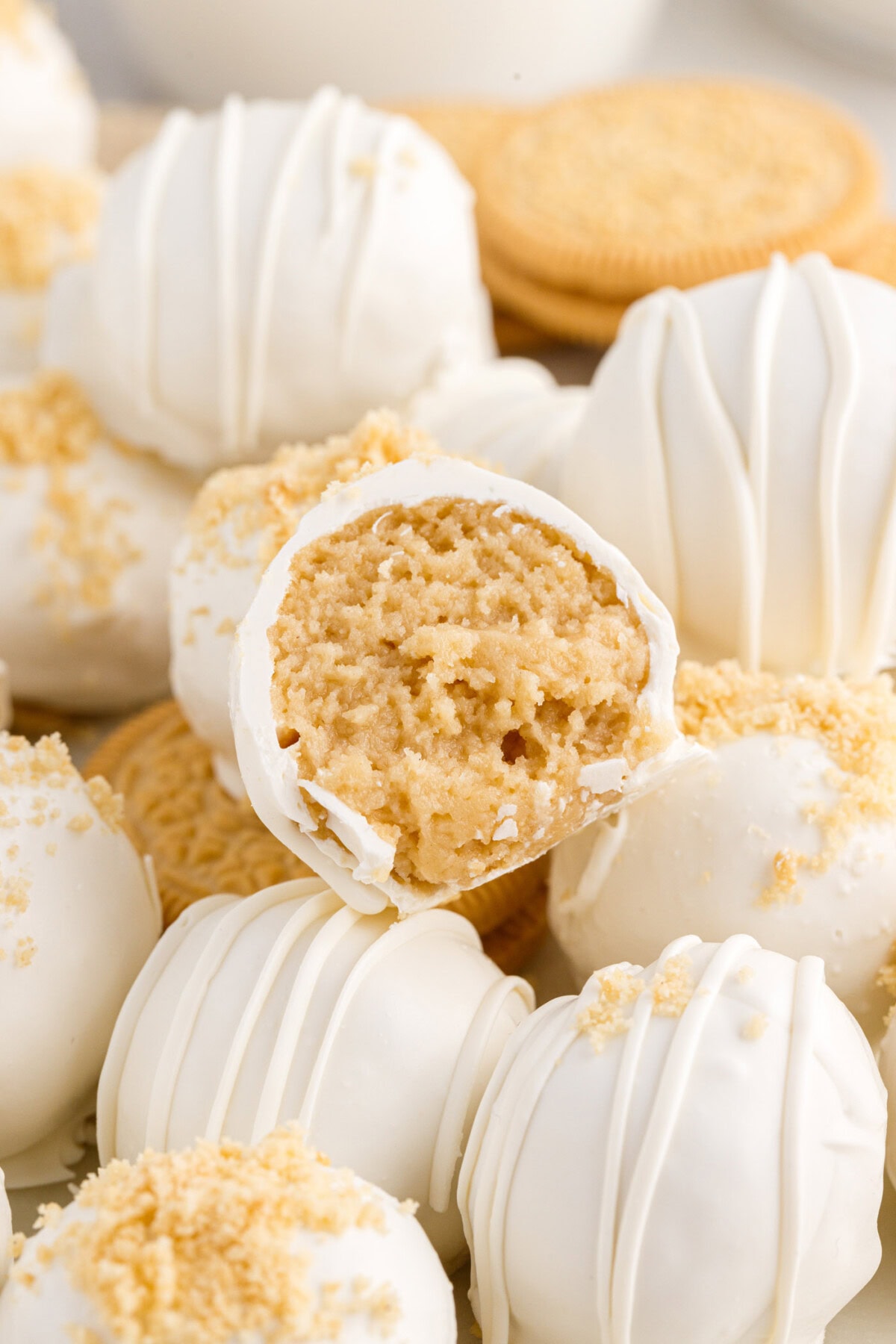 Close up photo of a Golden Oreo Truffle with a bite taken out