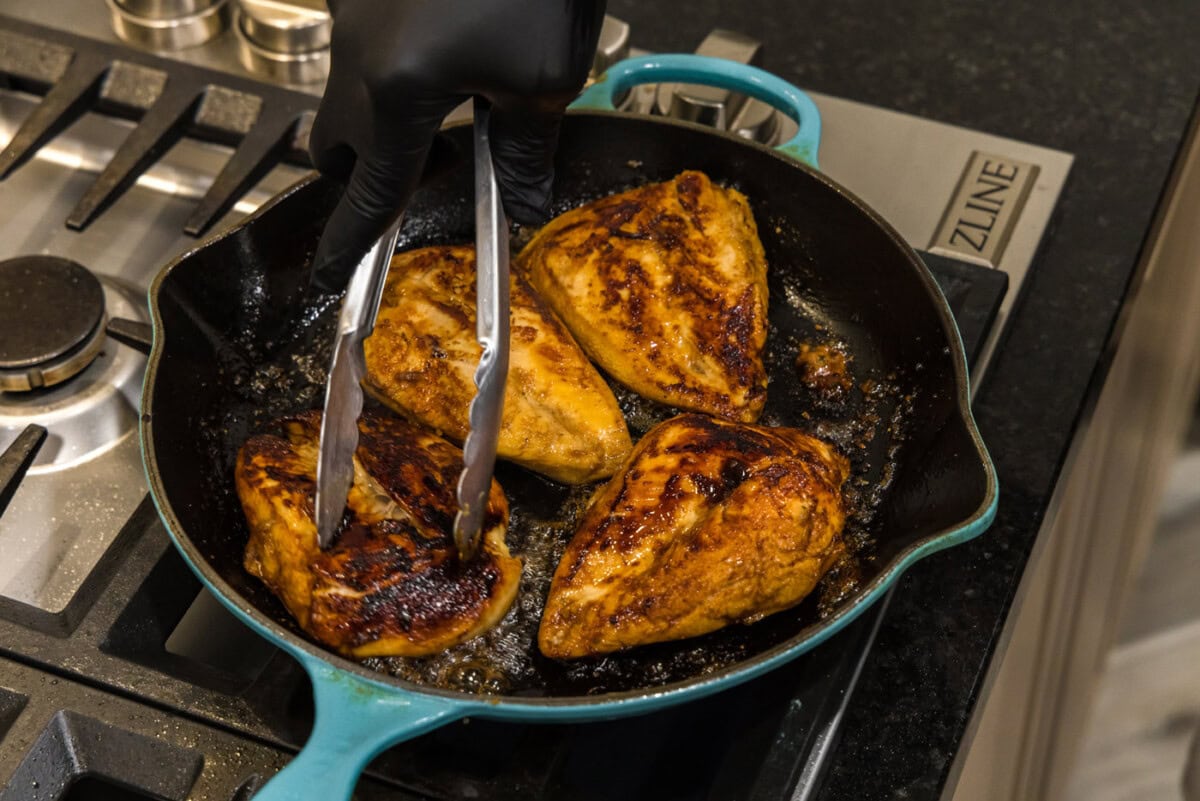 searing chicken breasts in a skillet
