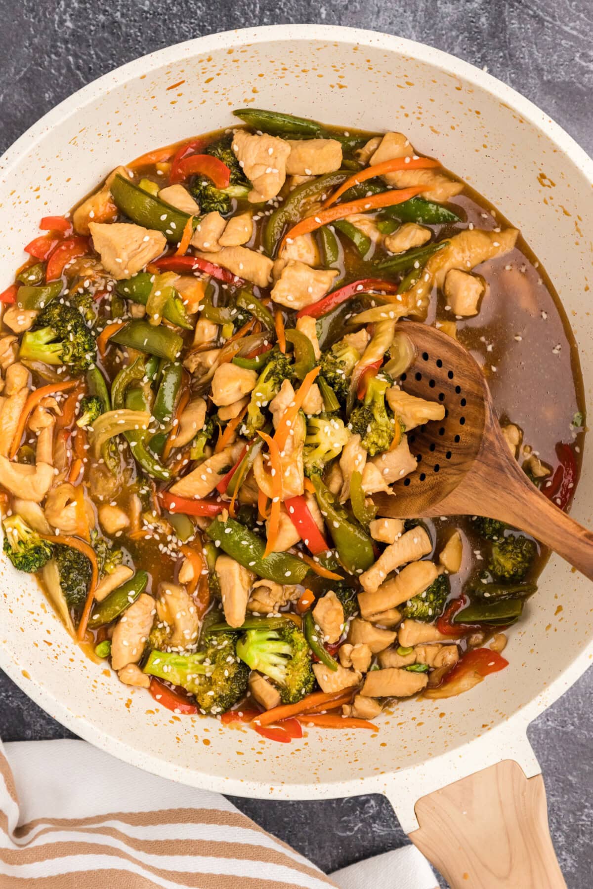 Skillet of Honey Garlic Chicken Stir Fry with a spoon in it
