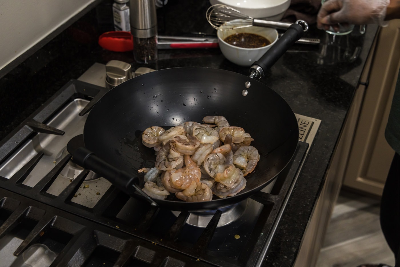 stir frying shrimp in a wok