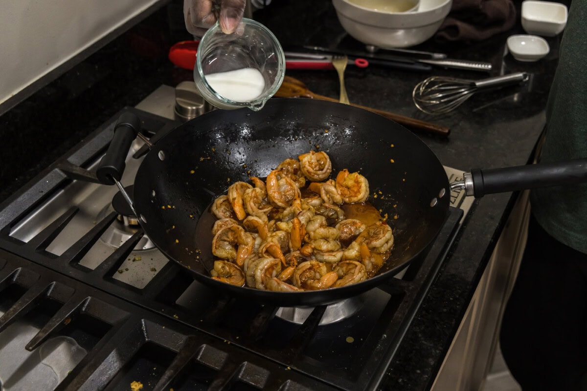 pouring a cornstarch slurry into hunan shrimp