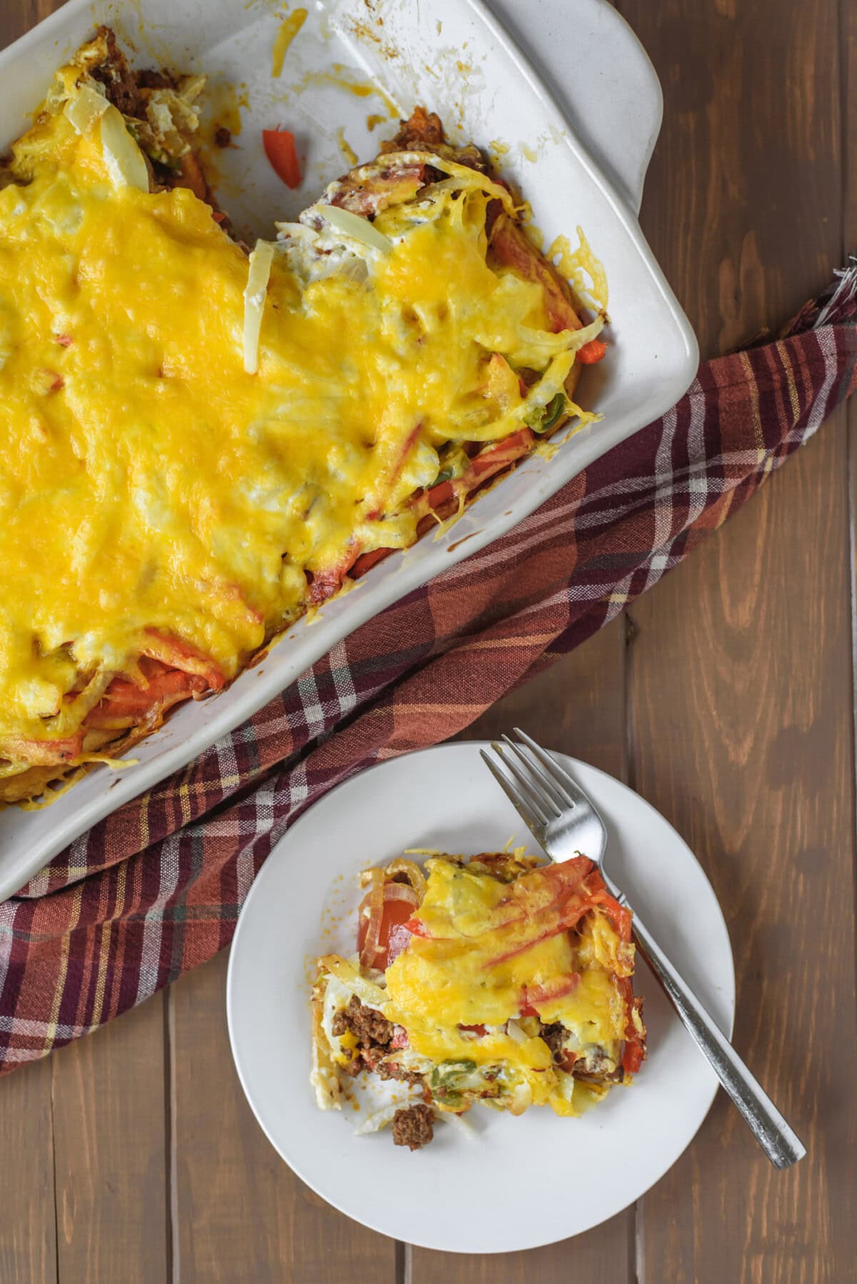 Plate of John Wayne Casserole next to a pan of John Wayne Casserole