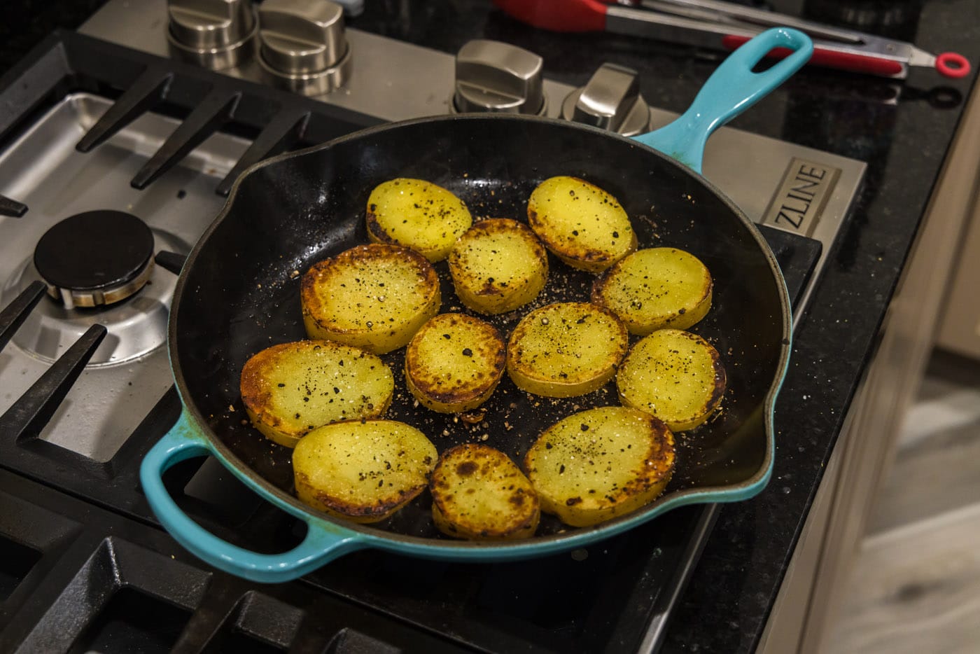 browned potato slices cooked in a skillet