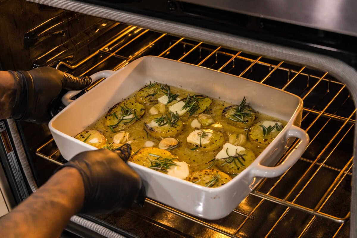 placing melting potatoes into the oven