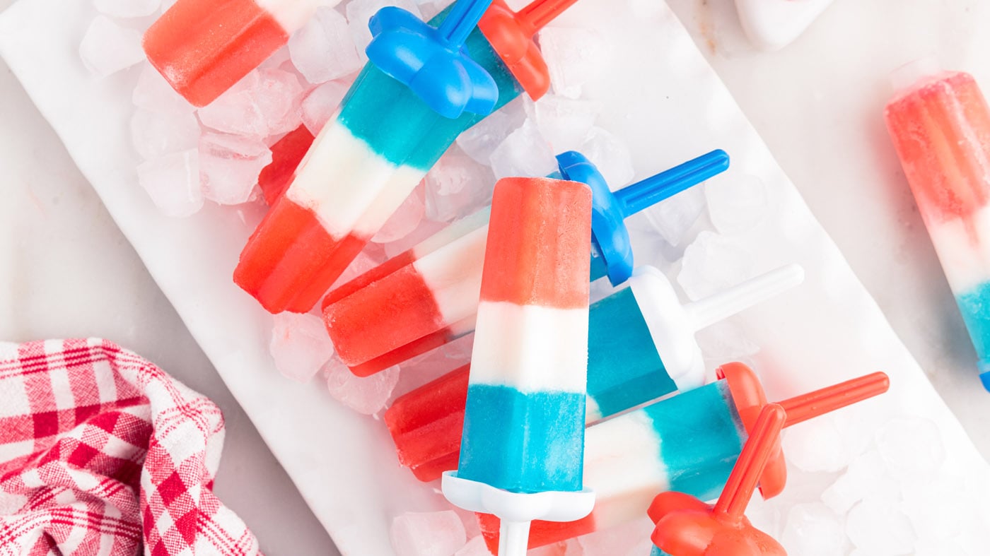 This patriotic bomb pops recipe is made with only 4 ingredients and a popsicle mold, just in time fo