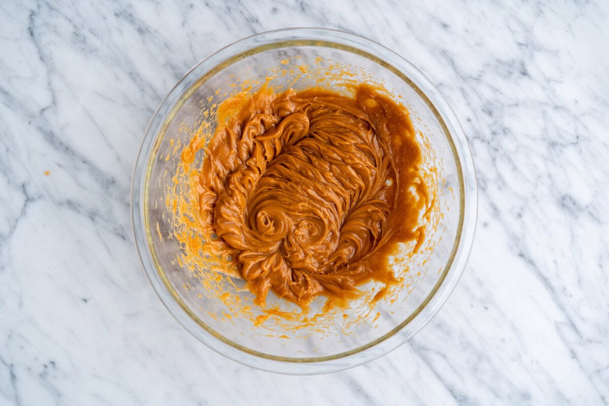 eggs, oil, and peanut butter mixed in a bowl