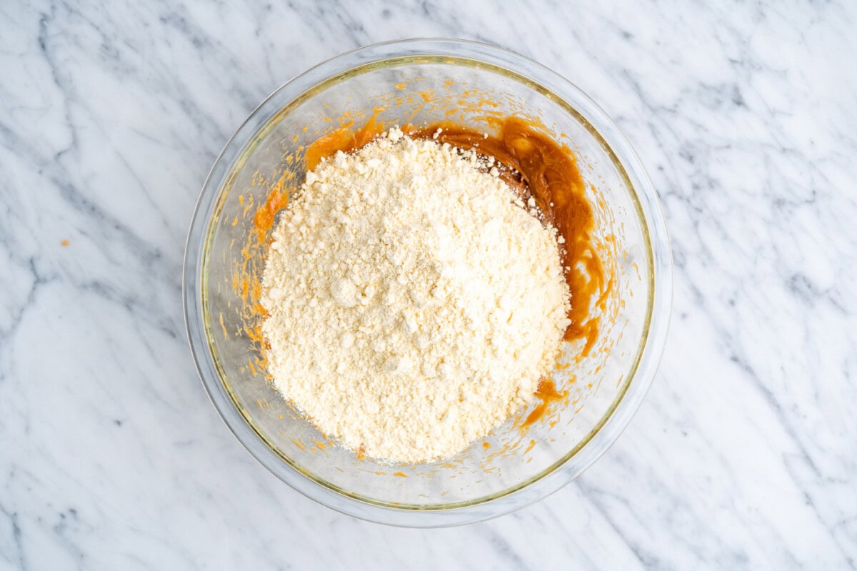 cake mix added to peanut butter mixture in a bowl