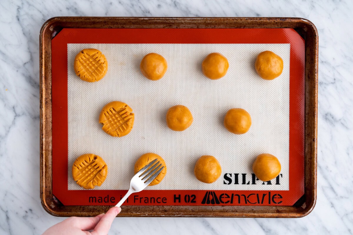pressing peanut butter cookie dough with a fork