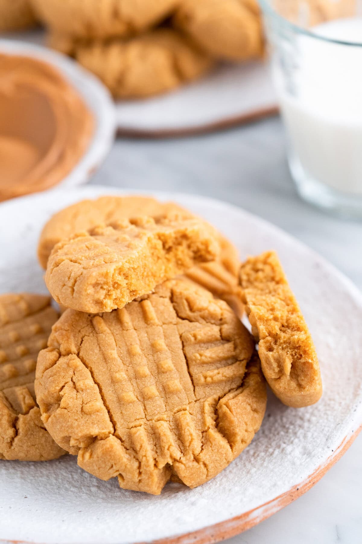 Peanut Butter Cake Mix Cookies on a plate with the top one broken in half