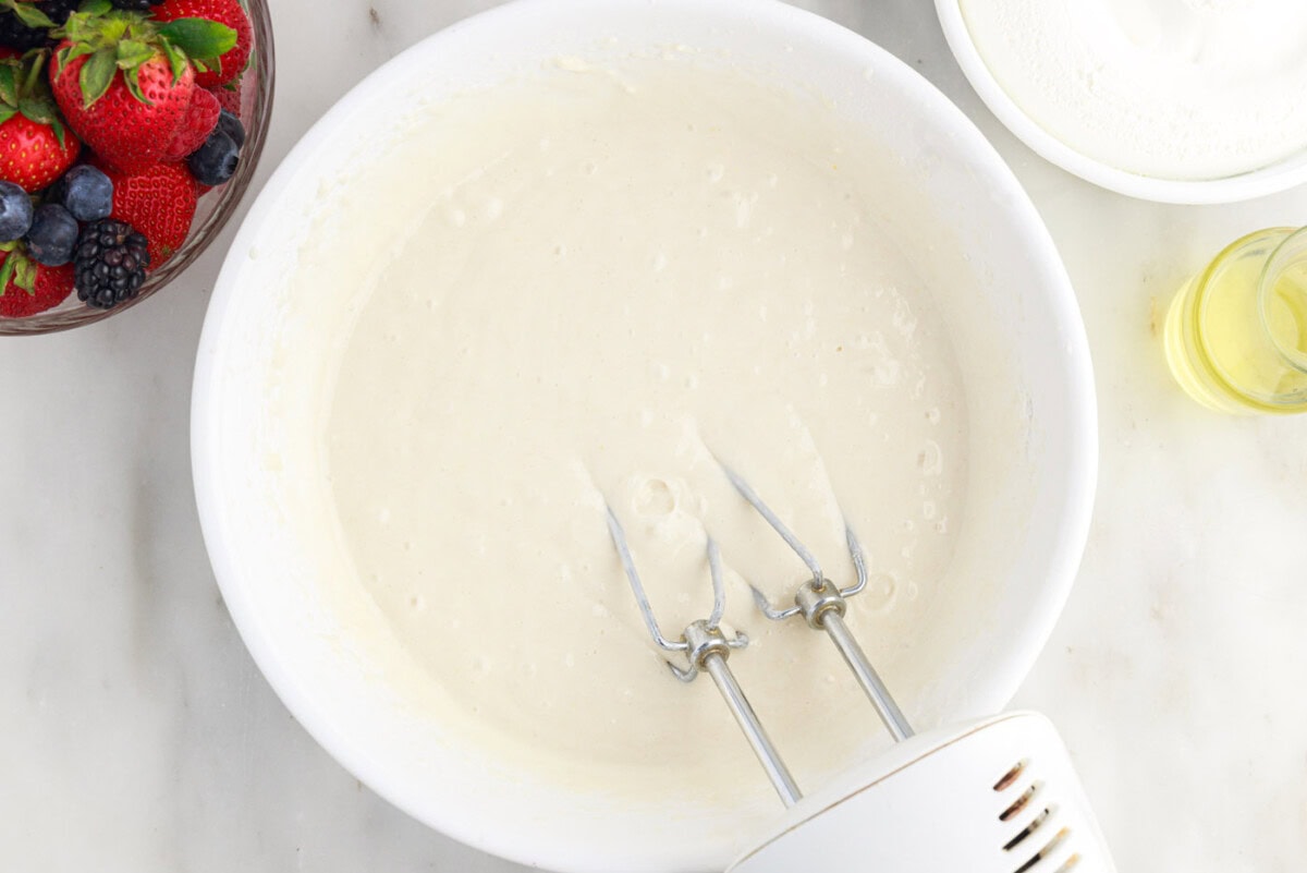 hand mixer combining cake batter ingredients