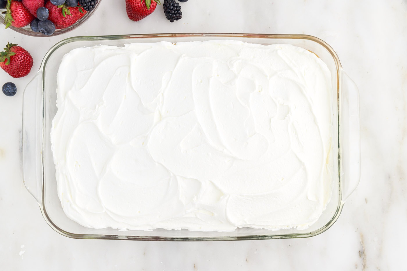 red white and blue cake topping with Cool Whip frosting