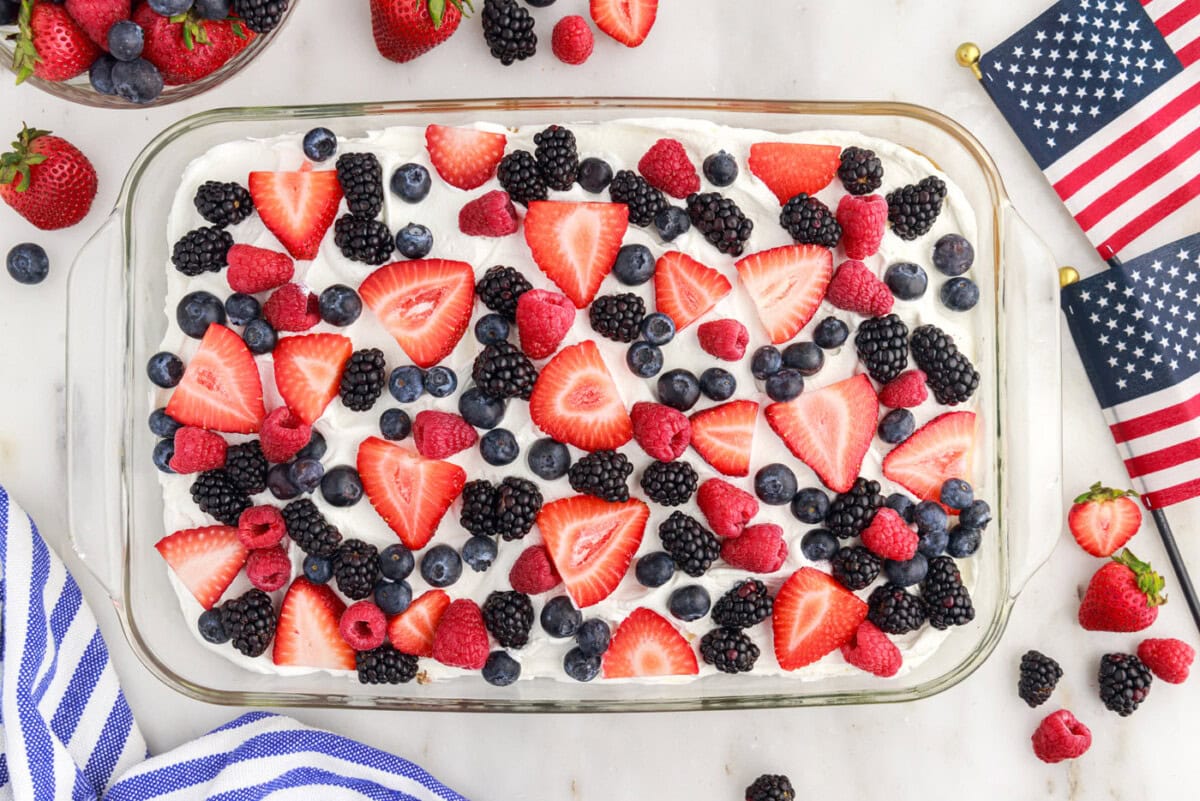 berries on top of red white and blue marble cake